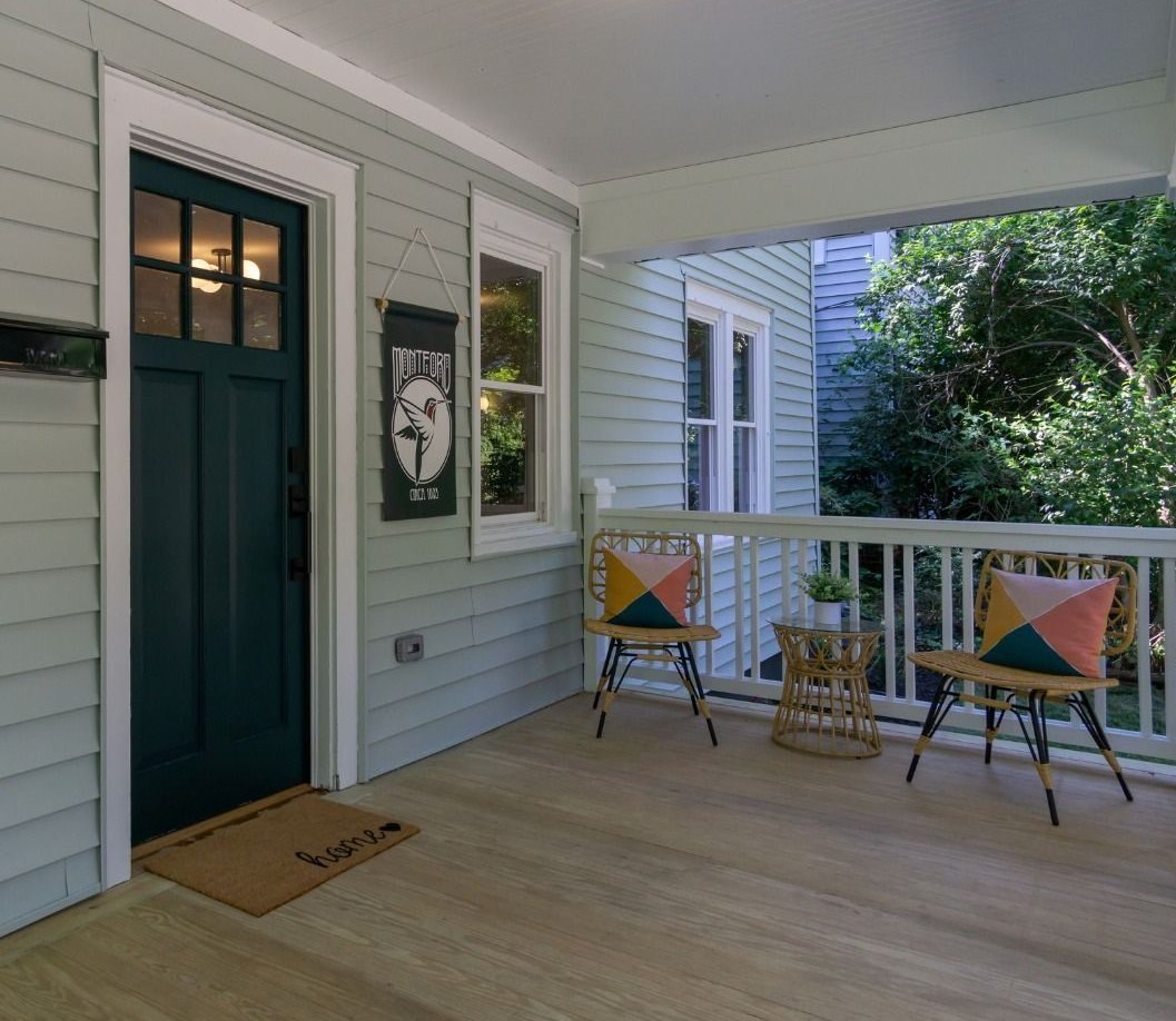 Front porch after: gray siding, a green craftsman door and new white railings
