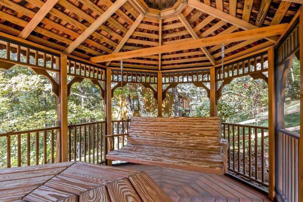 Inside a wooden gazebo with a built-in bench