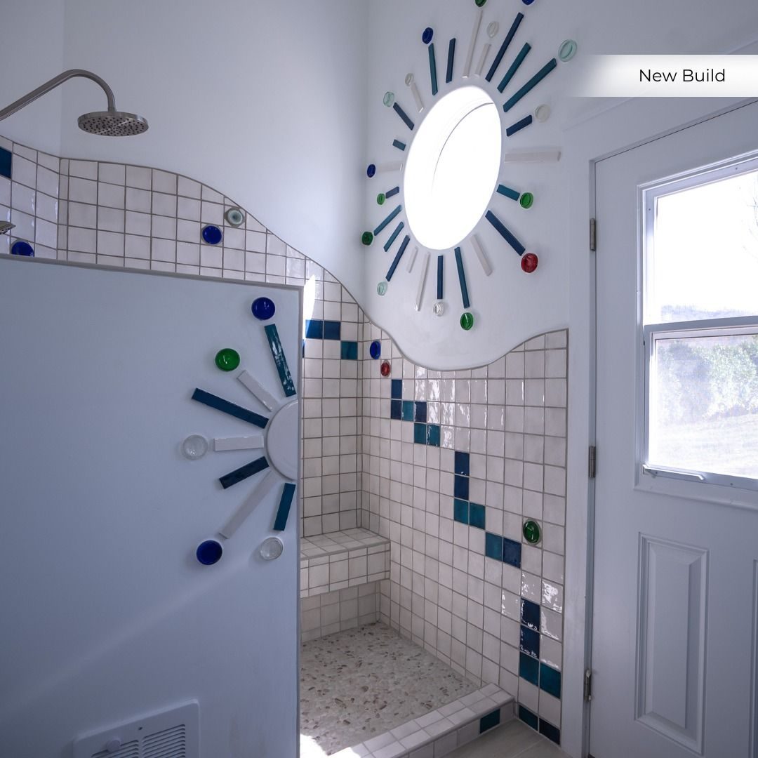 Tiled walk-in shower with a playful mosaic pattern