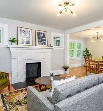 Living room with a white brick fireplace and a gray sofa