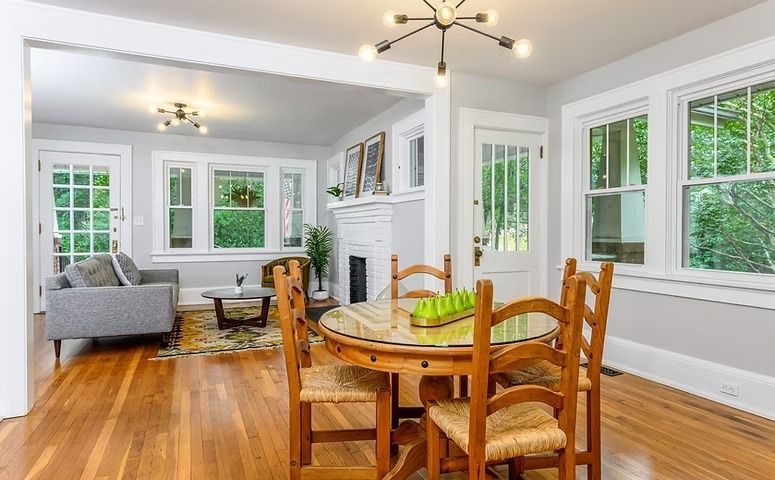 Living and dining room with hardwood floors and many windows